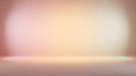A soft, blurred gradient background with warm pastel tones and a gentle spotlight effect creating a diffused glow.の素材