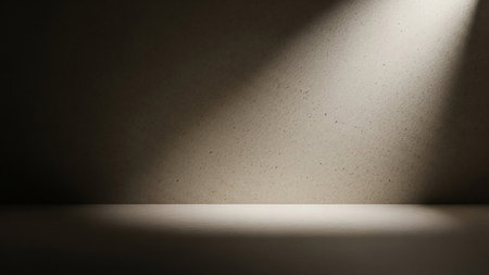 A textured wall with dramatic light rays and shadows, creating a moody and atmospheric backdrop.の素材