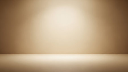 An empty studio background with a soft gradient from beige to brown, illuminated by a subtle spotlight from above.の素材