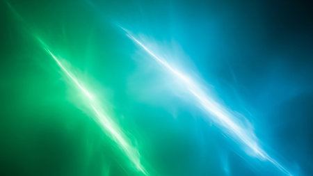 Two bright, glowing streaks of light, one green and one blue, streak diagonally across a dark, abstract background with subtle light effects.の素材