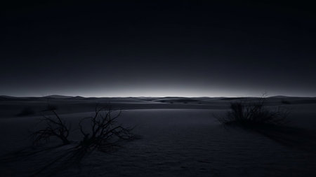 A desolate desert landscape at night features dark sand dunes and the stark silhouettes of dead, dry branches against a dark sky.の素材