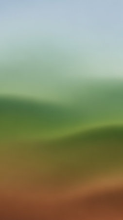 An abstract, softly blurred image features a gradient of serene blue, green, and brown hues, creating a tranquil and atmospheric visual.の素材