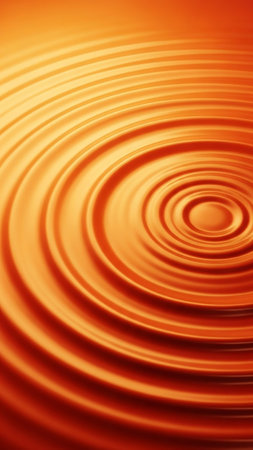 Close-up of concentric orange ripples on a liquid surface creating a dynamic abstract pattern with smooth gradients and flowing motion.の素材