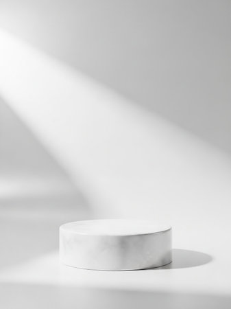 A simple white cylindrical pedestal sits on a white surface, bathed in soft diagonal light rays creating subtle shadows and a clean aesthetic.の素材