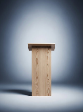 A plain wooden lectern stands centered on a light gray background, illuminated by a spotlight from above.の素材