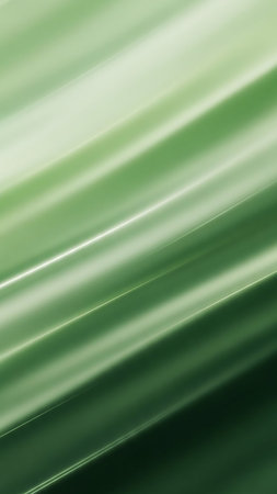 Abstract diagonal streaks of light in shades of green and white create a smooth, flowing motion against a soft gradient background.の素材