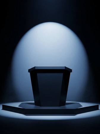 A dark, octagonal pedestal is dramatically lit by a single, bright spotlight from above in a dimly lit, minimalist room.の素材