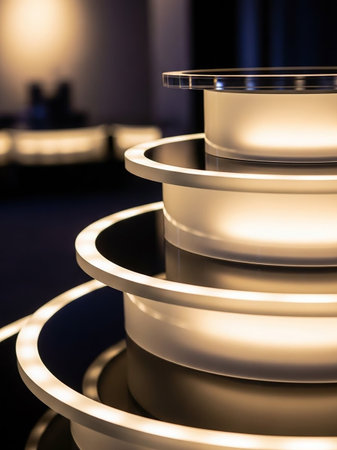 A close-up view of stacked translucent cylinders illuminated by integrated LED lighting, showcasing a modern and abstract design.の素材
