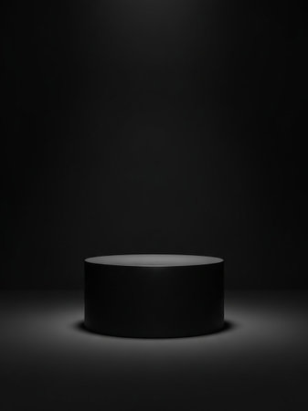 A dark, cylindrical pedestal sits centered in a dimly lit studio with a soft spotlight shining from above.の素材