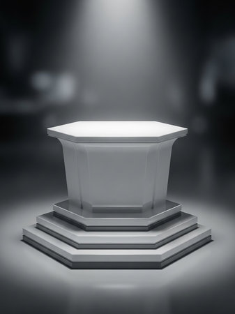 A clean, white octagonal pedestal sits on a multi-tiered gray base, illuminated by a soft spotlight from above in a dark studio setting.の素材