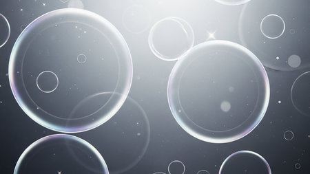 Translucent soap bubbles of varying sizes float in a soft focus background with gentle light reflections and bokeh effects.の素材