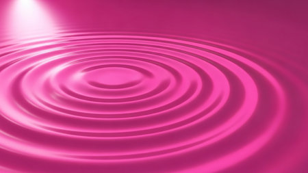 A vibrant pink liquid surface displays smooth, concentric ripples with soft light reflections, creating an abstract and dynamic visual texture.の素材