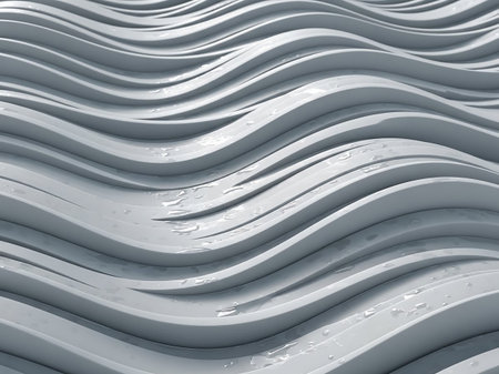 A close-up view of a smooth, wavy surface with small water droplets scattered across its undulating lines, reflecting light.の素材
