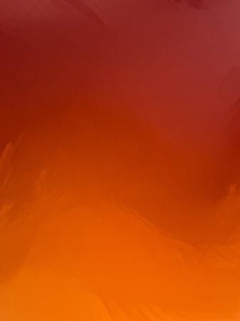 A soft gradient transitions from warm red to bright orange, featuring a painterly texture with subtle brush strokes and a sense of fluid motion.の素材