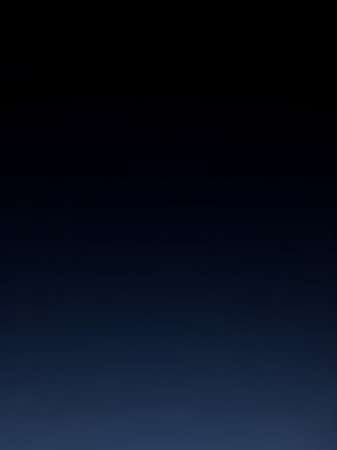 A deep navy blue to black gradient background with a subtle hint of lighter blue at the bottom, creating a smooth, atmospheric transition.の素材