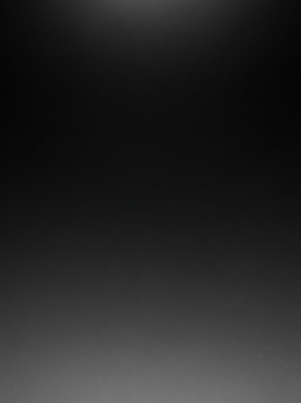 Simple showing a smooth, dark gray to black gradient background with subtle texture and a faint light source at the keywords: dark, gray, black, gradient,...の素材