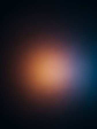 Warm showing abstract gradient of warm orange and cool blue light blending into dark background. resolution use.の素材