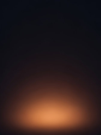 Warm showing abstract background with a soft gradient of dark gray to warm orange light at the bottom creating a subtle and minimalist effect. resolutionの素材