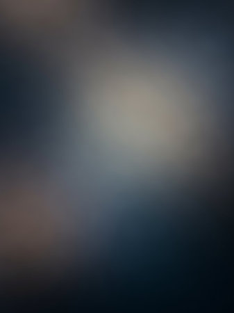 A softly blurred abstract background smooth transitions between dark gray-blue and lighter neutral tones, creating a moody atmosphere.の素材