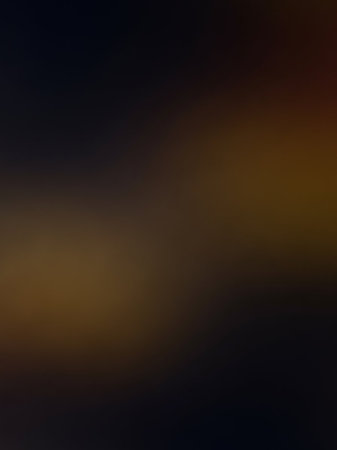 Black showing a dark, moody, and abstract background with a soft, out of focus gradient transitioning from deep brown and black to a warm, diffused golden light in...の素材