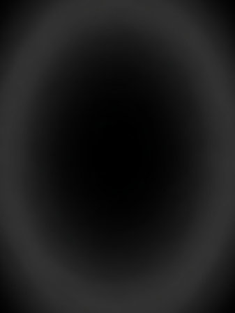 Center showing a dark, black abstract background with a subtle, soft gray circular vignette or halo effect radiating from the center, creating a mysterious and...の素材