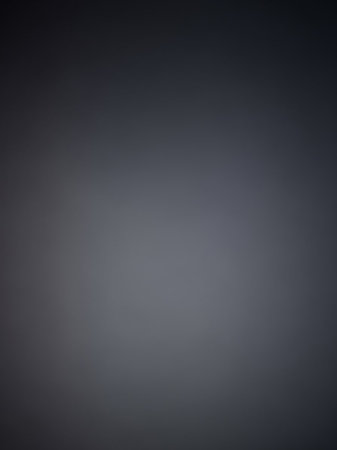 Stock showing dark gray smooth gradient background with subtle vignette effect and soft blurry transition from darker edges to lighter center. resolutionの素材