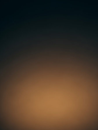 A smooth, blurred gradient transitions from dark blue at the to a warm brown at the bottom, with subtle ambient lighting.の素材