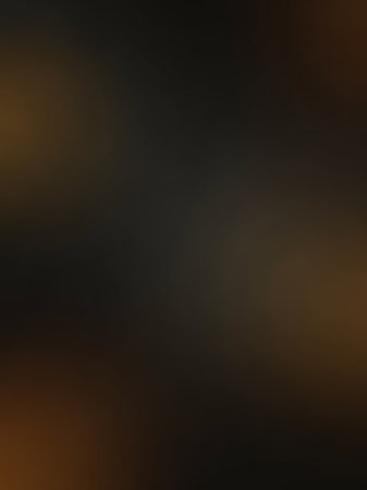 Warm showing dark brown and black gradient soft focus background with subtle warm tones and a smooth blurry texture for abstract and digital applications.の素材