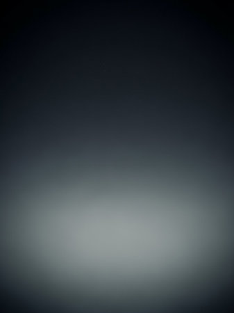 Gray showing dark gray to light gray soft gradient background with a subtle spotlight effect at the bottom for minimalist and subtle lighting concepts.の素材