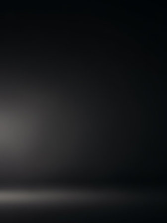 Floor showing dark gray studio background with a subtle light source creating a soft glow on the floor. resolution use.の素材