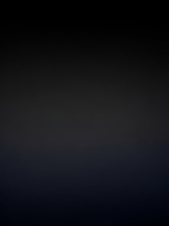 A smooth gradient transitions from dark gray at the to a deep blue at the bottom with subtle lighting effects and soft edges.の素材