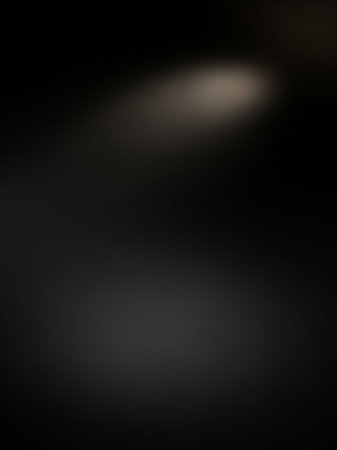 A dark moody background is subtly illuminated by a soft, diffused spotlight in the upper portion of the frame.の素材