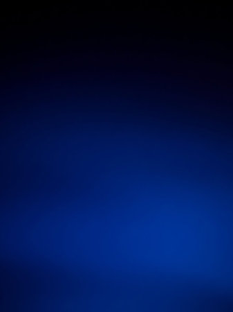 A deep dark blue gradient transitions smoothly from black to a vibrant electric blue, creating a rich and intense color field.の素材