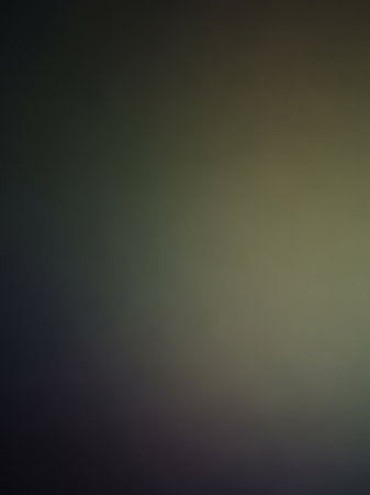 A dark, abstract background with a smooth gradient from deep grey to muted olive green and dark blue, offering a somber and atmospheric visual texture.の素材