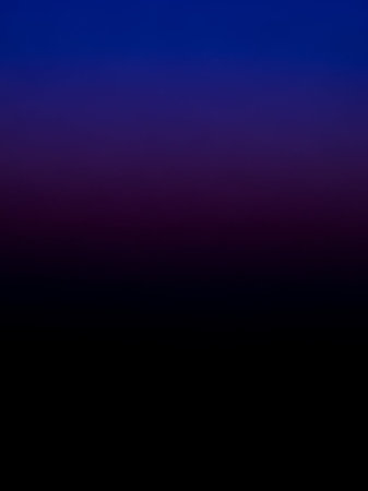A smooth, deep gradient transitions from a rich royal blue at the to a dark purple and finally to black at the bottom.の素材