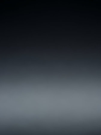 A smooth, subtle gradient transitions from a deep dark blue at the to a lighter grey at the bottom of the frame.の素材