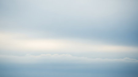 Simple showing minimalist horizon with soft blue sky blending into a faint white and light blue haze with a subtle line of low clouds keywords: sky, blue, white,...の素材