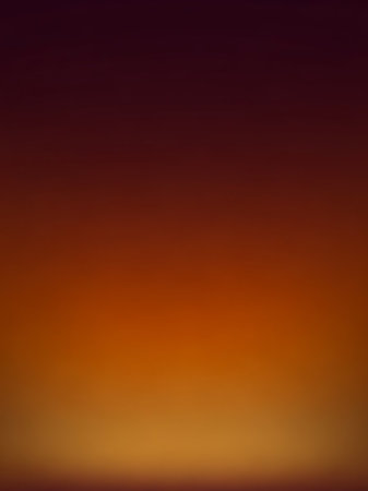A smooth, blurred gradient transitions from deep red and orange to yellow, creating a warm, abstract background with soft lighting.の素材