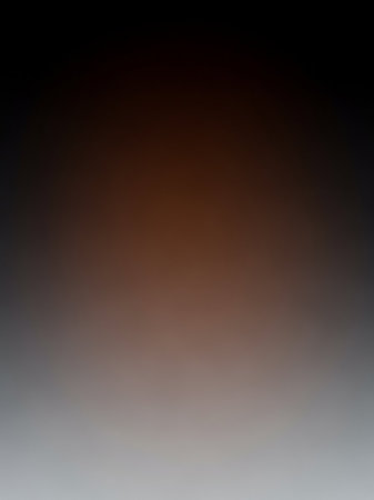 Warm showing smooth gradient transition from deep black at the to warm brown and then light grey at the bottom creating an abstract background keywords: gradient,...の素材