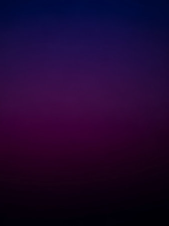 A smooth, seamless gradient transitions from a deep indigo blue at the to a rich dark purple, fading into near-black at the bottom, creating a dark, abstract color...の素材