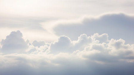 Bright sunlight illuminates soft, voluminous white cumulus clouds, creating a dreamy and ethereal atmosphere in a serene sky scene.の素材