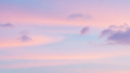 A soft, diffused pastel sky gentle pink and pale blue hues with subtle, wispy clouds, creating a dreamy and serene atmosphere.の素材