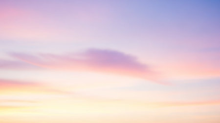 A soft pastel sky with gentle pink, yellow, and lavender hues blending through wispy clouds, creating a dreamy atmosphere.の素材