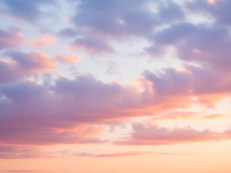 A serene pastel sky at sunset, featuring soft pink and purple clouds gently blending into a pale orange horizon, creating a romantic atmosphere.の素材