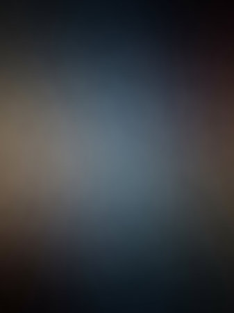 A softly blurred background a gradient of dark blue-gray blending into warm brown tones, creating a smooth and atmospheric effect.の素材