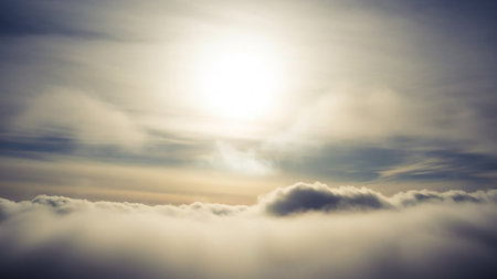 Luminous showing a bright, intense sun shines from the upper center through a hazy sky filled with soft, diffused clouds and a layer of fluffy clouds below...の素材