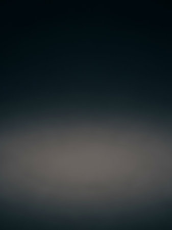 A minimalist background featuring a deep dark blue gradient that subtly fades to a lighter grey at the bottom, creating a smooth, atmospheric texture.の素材