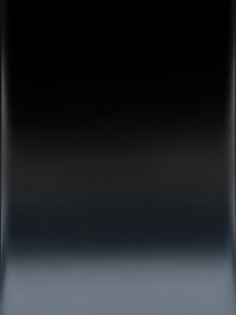 A dark metallic gradient with subtle reflective highlights and a smooth, polished surface creates a deep, abstract background with a sleek, feel.の素材