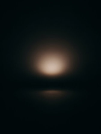 Stock showing softly glowing diffused light source creating a hazy ethereal atmosphere with a subtle reflection on a dark surface keywords: light, glow, diffused,...の素材