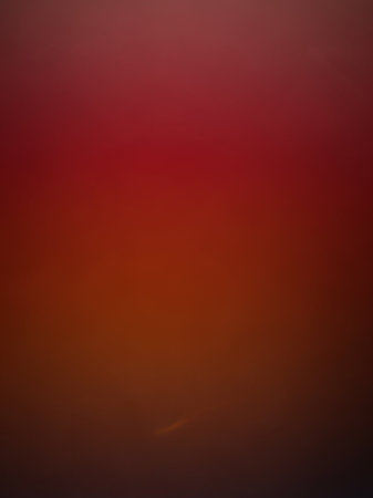 Field showing softly blurred gradient of deep red transitioning to dark orange and black creating an abstract atmospheric background effect keywords: abstract,...の素材